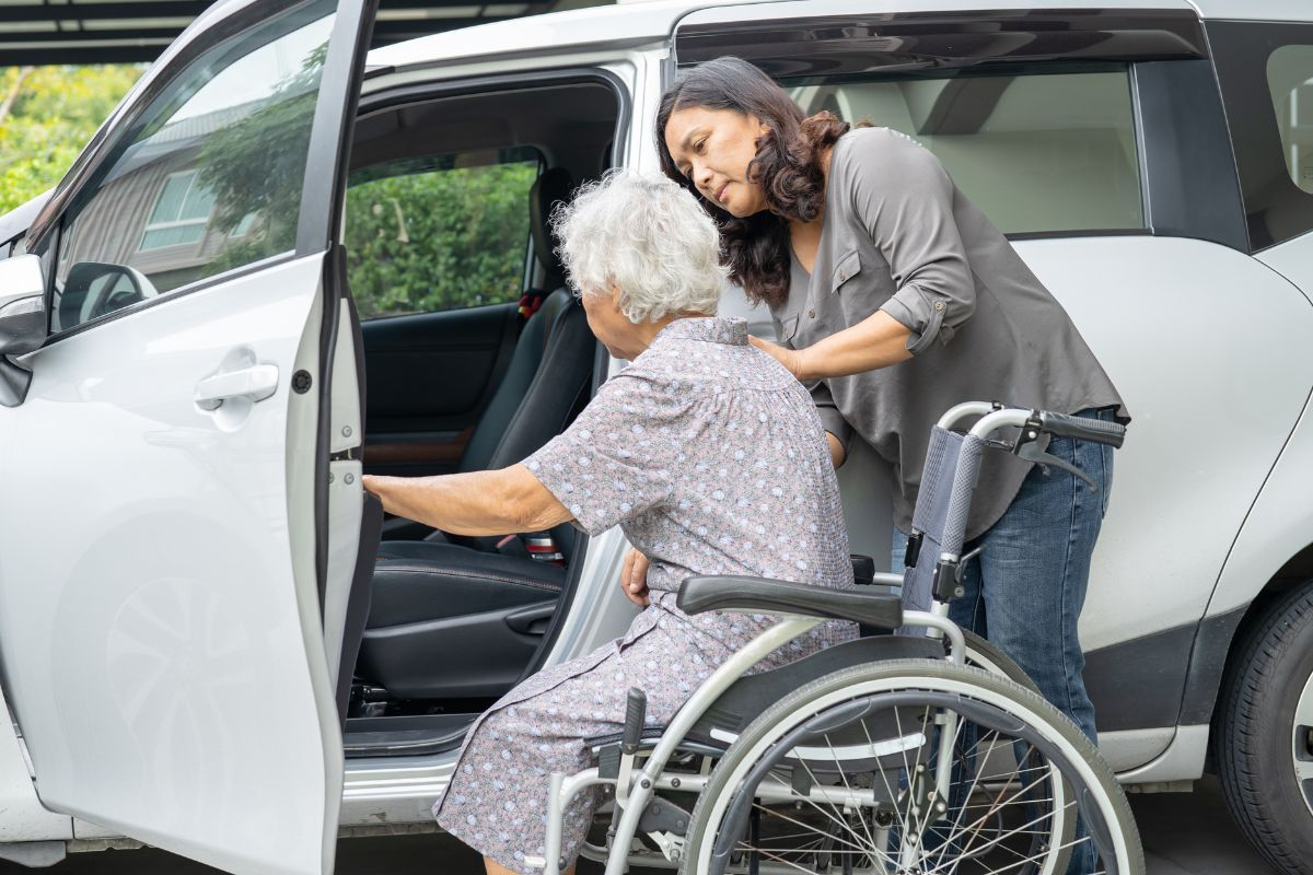 Helping patient into car